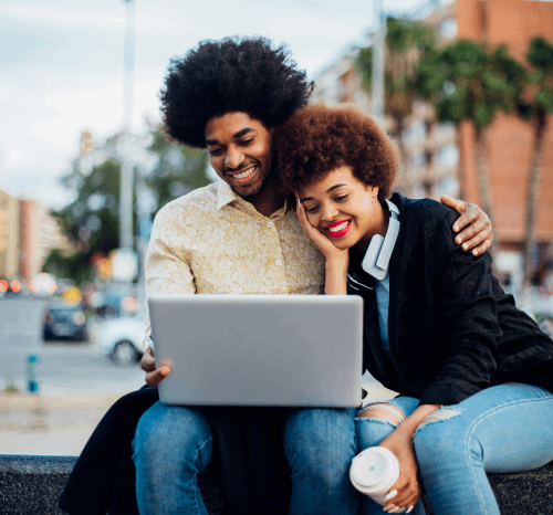 man and woman looking at a laptop